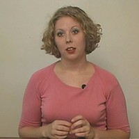 Cindy Fine Woman with short blonde hair wearing a medium-pink shirt